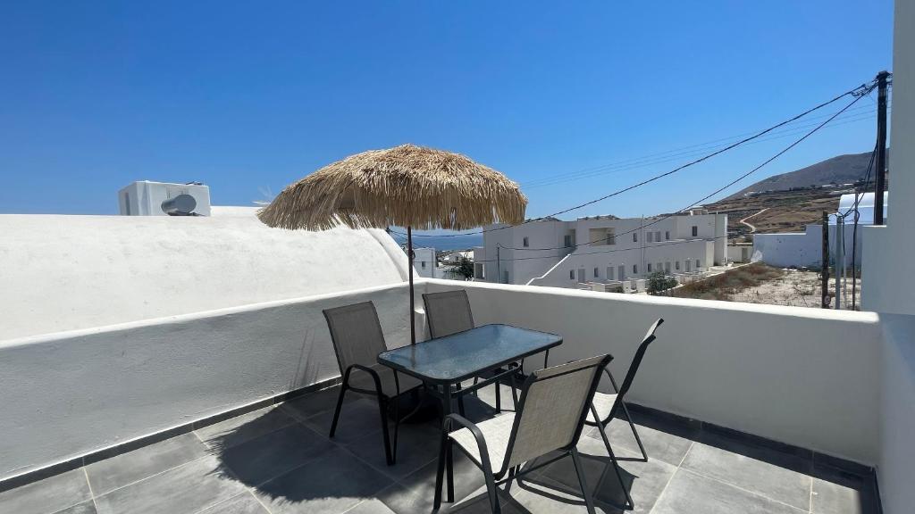 a table and chairs on a balcony with a view at Aliki's Apartments in Vóthon