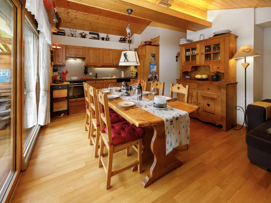 a kitchen and dining room with a table and chairs at Apartment Mon Abri B by Interhome in Les Diablerets