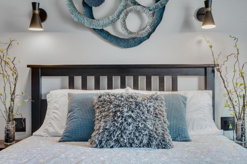 a bedroom with a bed with blue pillows at The Serenity Suite with Hot Tub- Main Street Lodge in Berlin in Berlin