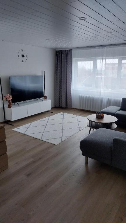 a living room with a large flat screen tv at Mugav mereäärne korter in Orissaare