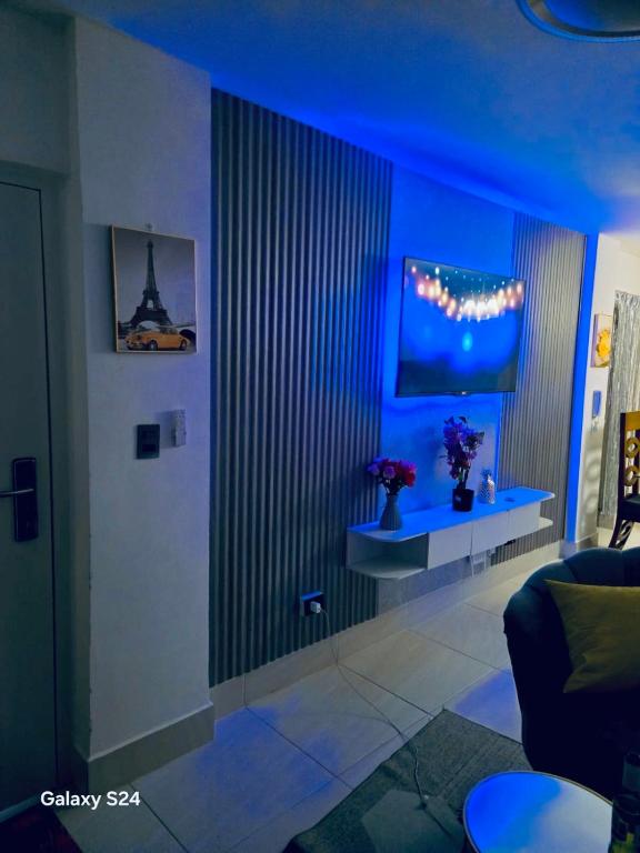 a blue room with a couch and a table at Peace Place in Santiago de los Caballeros