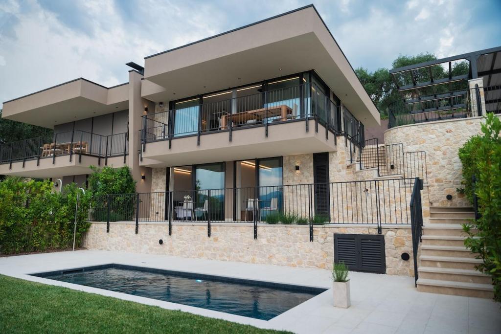 a house with a swimming pool in front of it at Villa Horizon in Torri del Benaco