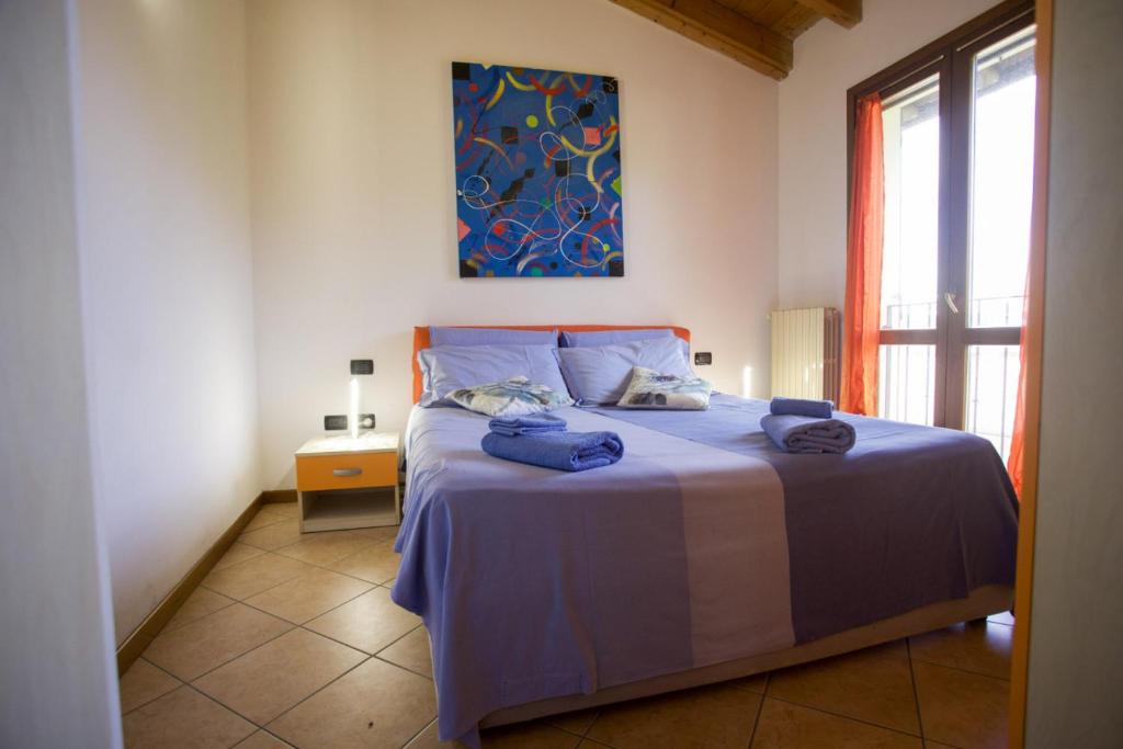 a bedroom with a bed with two towels on it at Fiordaliso in Montichiari