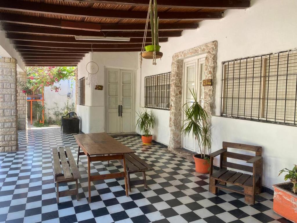 a patio with a table and chairs on a checkered floor at Complejo el cordobes in Albardón