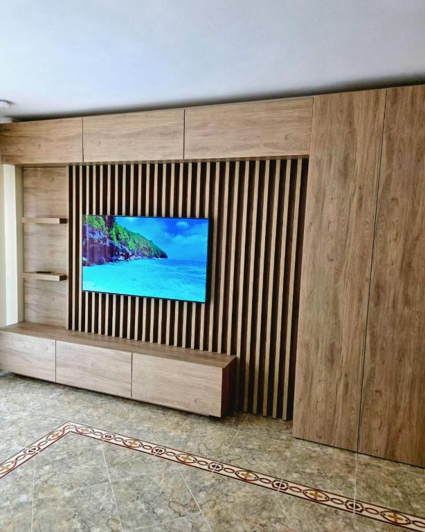 a flat screen tv sitting on a wooden wall at Entire Apartment near Valencia - 2 Bedrooms & 2 Bathrooms in Paterna