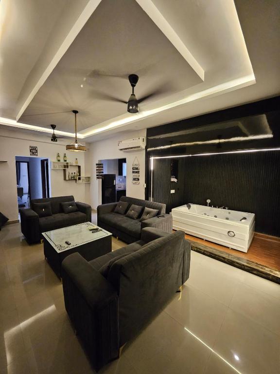 a large living room with a couch and a tub at The High View in Mohali
