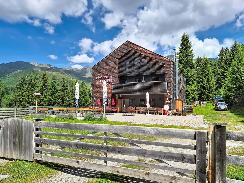 a barn with a fence in front of it at Apartment Naviser Hütte-3 by Interhome in Navis
