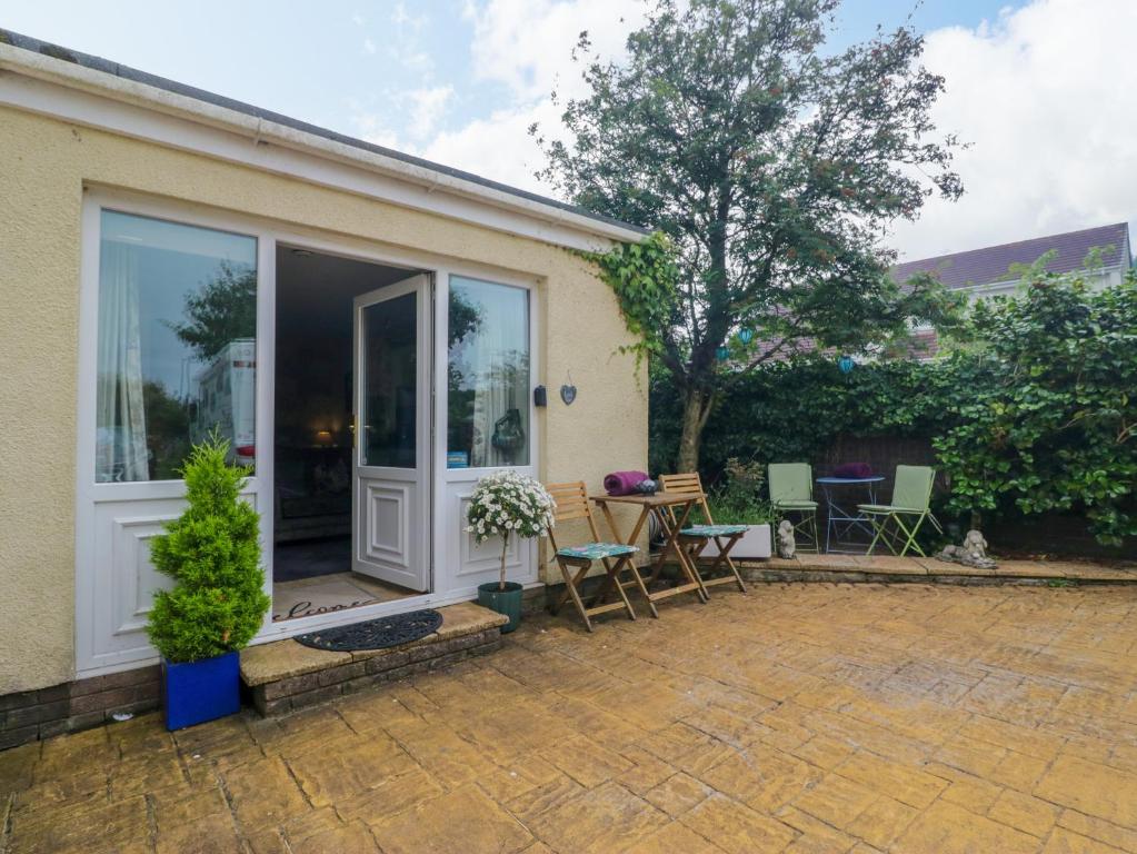 a house with a patio with a sliding glass door at La'al Yan in Workington