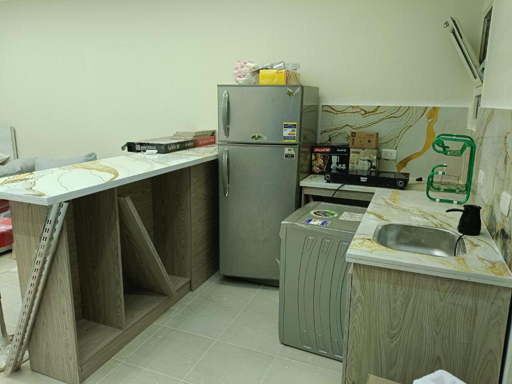 a kitchen with a stainless steel refrigerator and cabinets at 731 الكارما in El Gouna