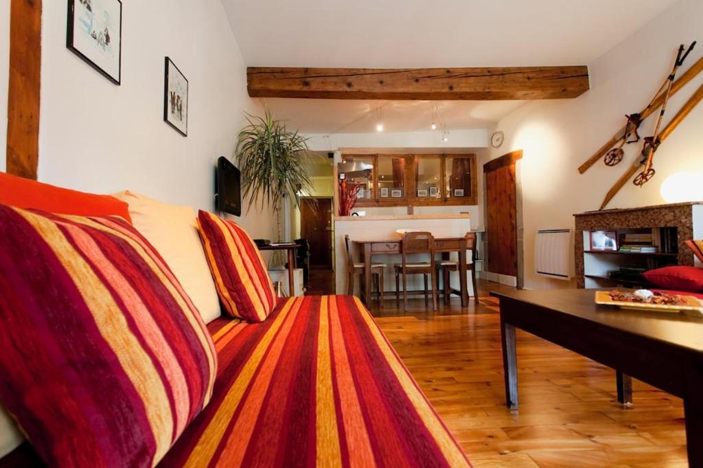 a living room with a couch and a table at Historic Centre Studio, St-André & Bastille view! in Grenoble