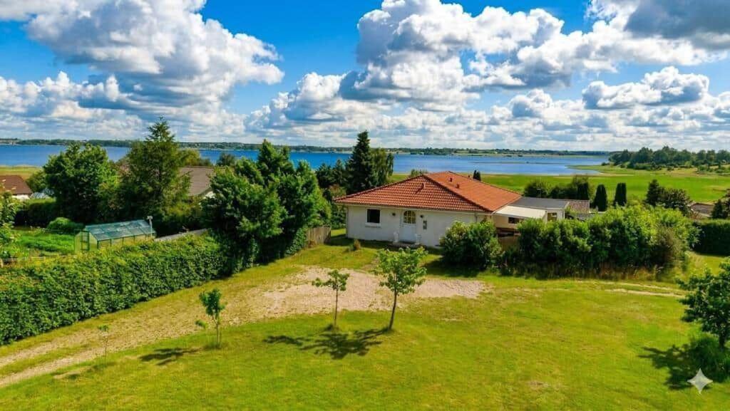 an aerial view of a house in a field with trees at FJ1603-Jaegerspris-Kystsvinget-3 in Jægerspris