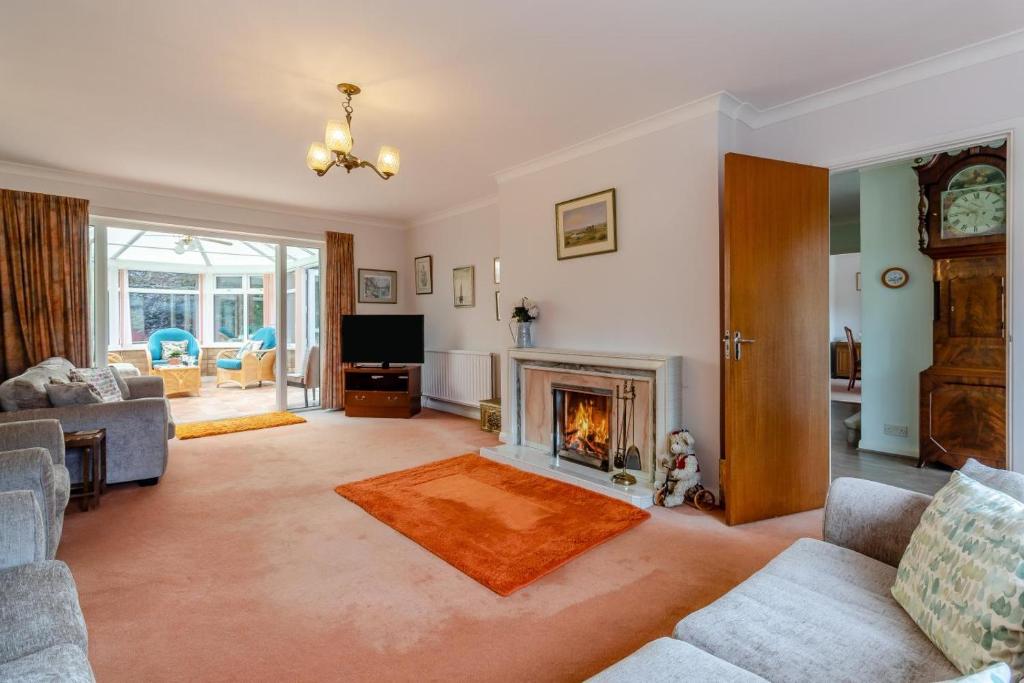 a living room with a fireplace and a couch at 4 Bed in Halesworth oc-willho in Halesworth