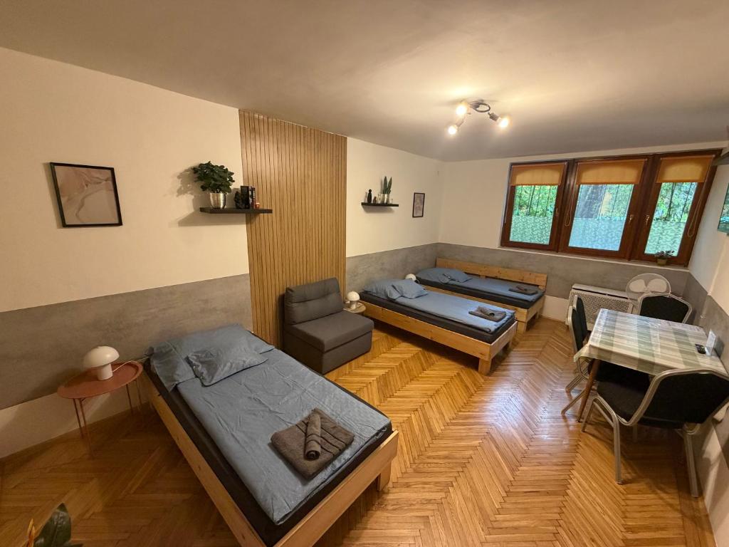 a room with two beds and a couch at Carlos Apartman Kecskemét in Kecskemét