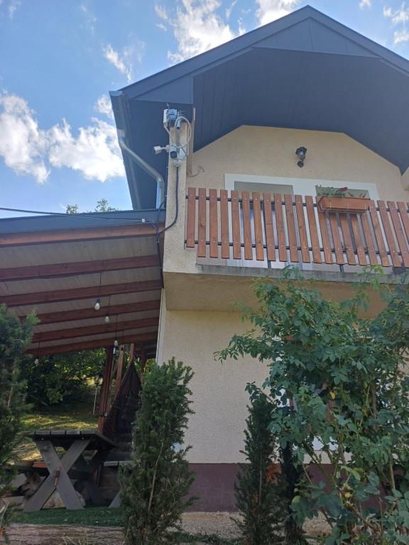 a house with a balcony on the side of it at LídRind porta in Zalaszentgrót