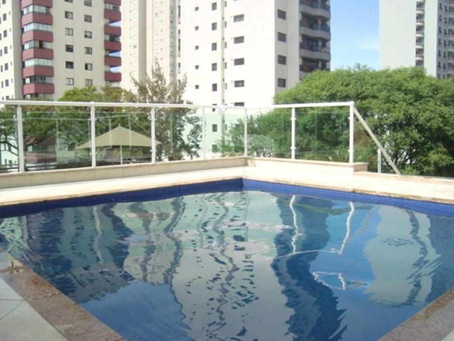 an empty swimming pool with buildings in the background at Upper Hotel in Sao Paulo