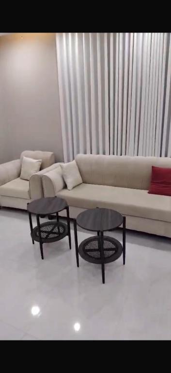 a living room with a couch and two tables at الصفا in Jeddah