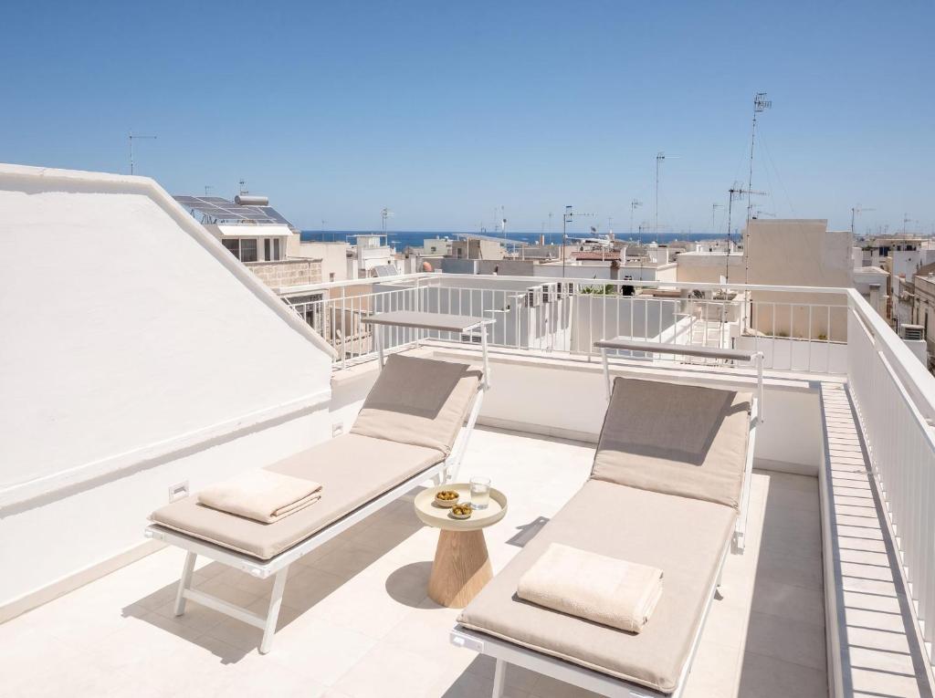 a balcony with two chairs and a table at Chiantera in Polignano a Mare