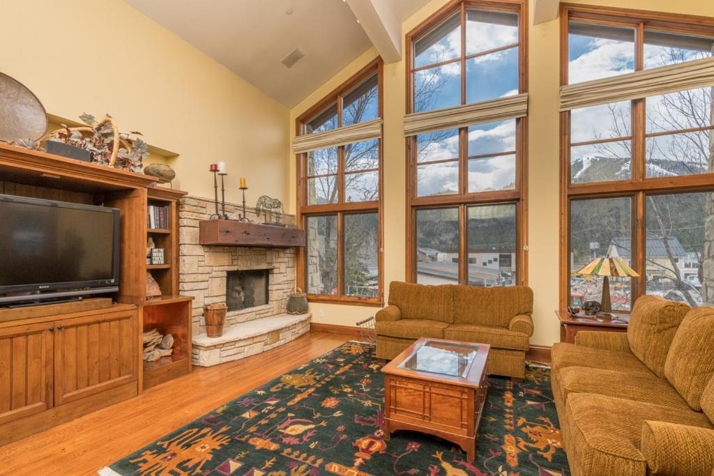 a living room with a television and a fireplace at Colonnade Residence - 14 at Ketchum in Ketchum