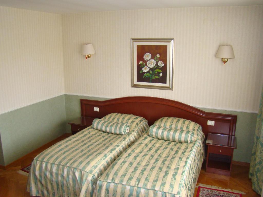 Postel nebo postele na pokoji v ubytování Hotel Vila Ariston