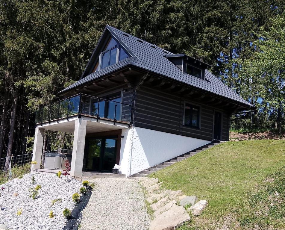 a black and white house on top of a hill at Chaty Korňa in Predmerská