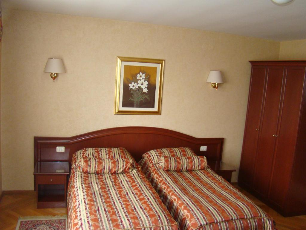 Postel nebo postele na pokoji v ubytování Hotel Vila Ariston