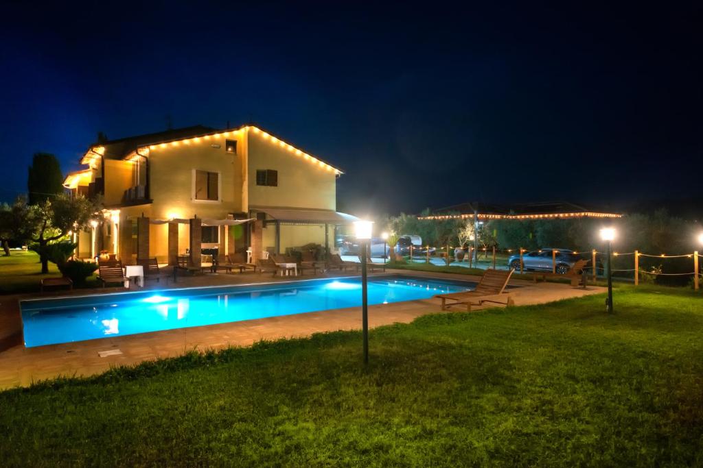 a house with a swimming pool at night at Il Nido del Falco in Montefalco