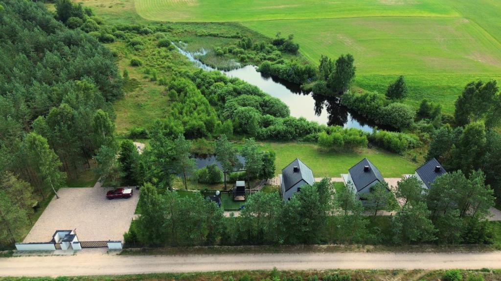 an aerial view of a house and a river at Lobeliowe Domki in Chośnica