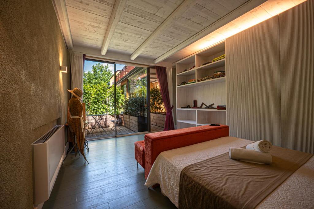 a bedroom with a bed and a large window at La Pampa Relais & Spa in Melizzano