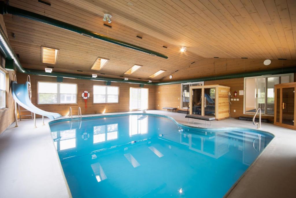 a large swimming pool in a room with at Private Heated Pool House with Sauna CL in Crystal Lake