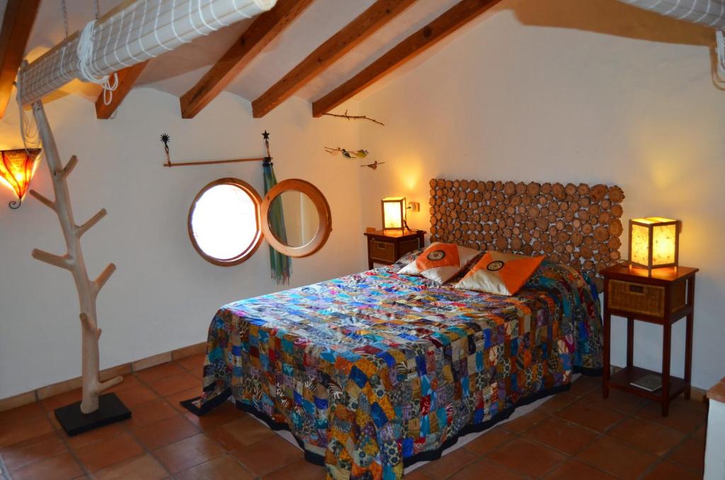 um quarto com uma cama e um espelho na parede em La Casa Del Teix em Eslida