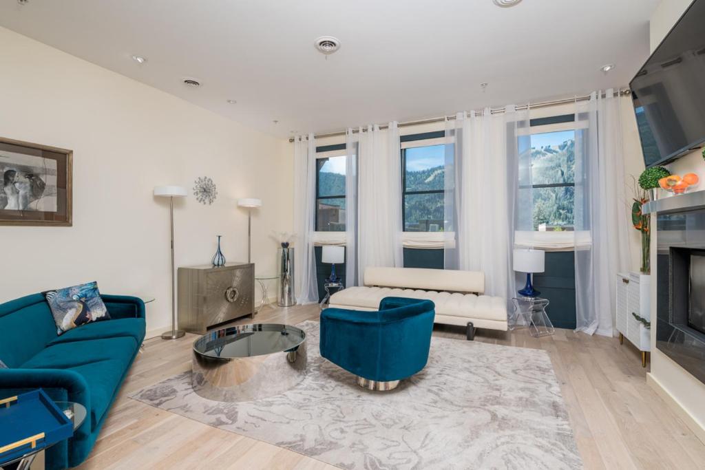 a living room with a blue couch and a table at Leadville Penthouse #8 in Ketchum
