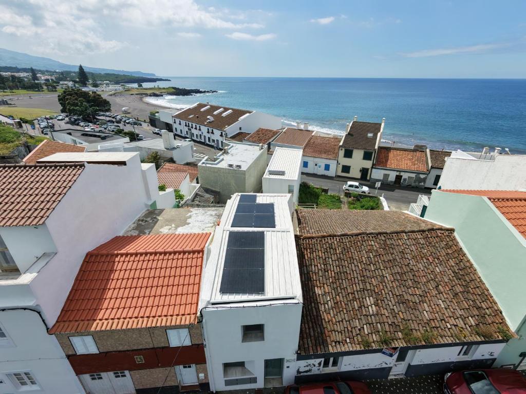 an aerial view of a town with houses and the ocean at Casa do Mar North in Ponta Delgada