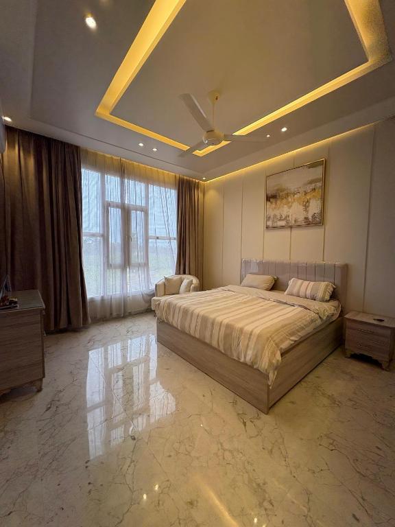 a large bedroom with a bed and a ceiling at بنايه بيت الشب in Ţāqah