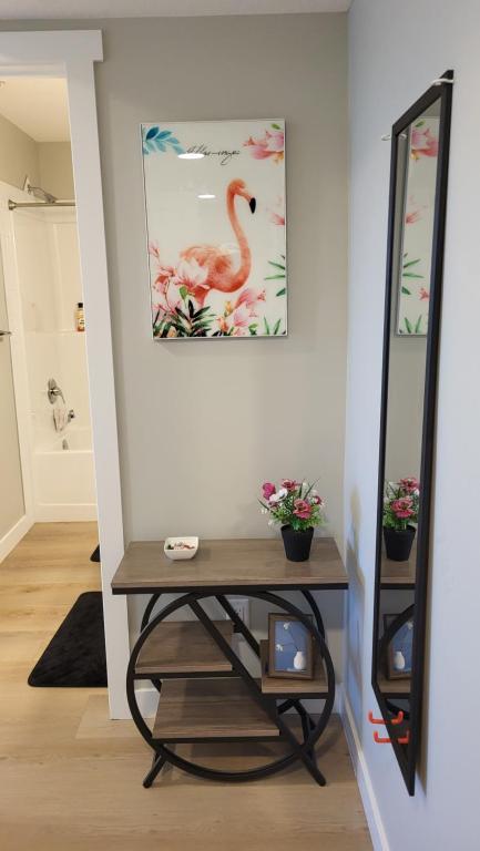 a dressing room with a table and a mirror at Heavenly Rest by JC in Edmonton