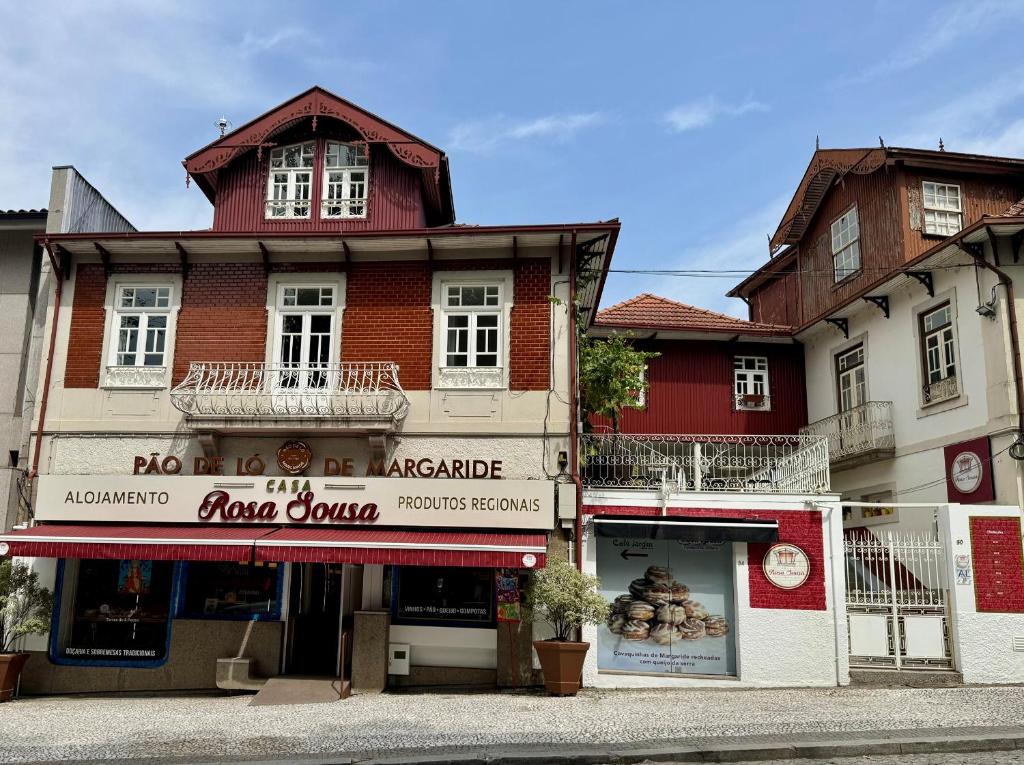a building with a store on the side of a street at Casa Rosa Sousa in Felgueiras
