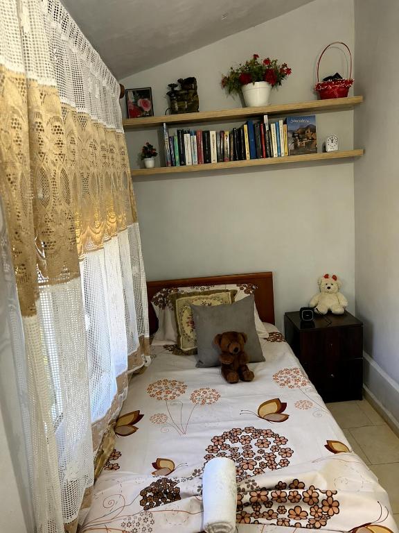a bedroom with a bed with a teddy bear on it at Koman Rest Point in Koman