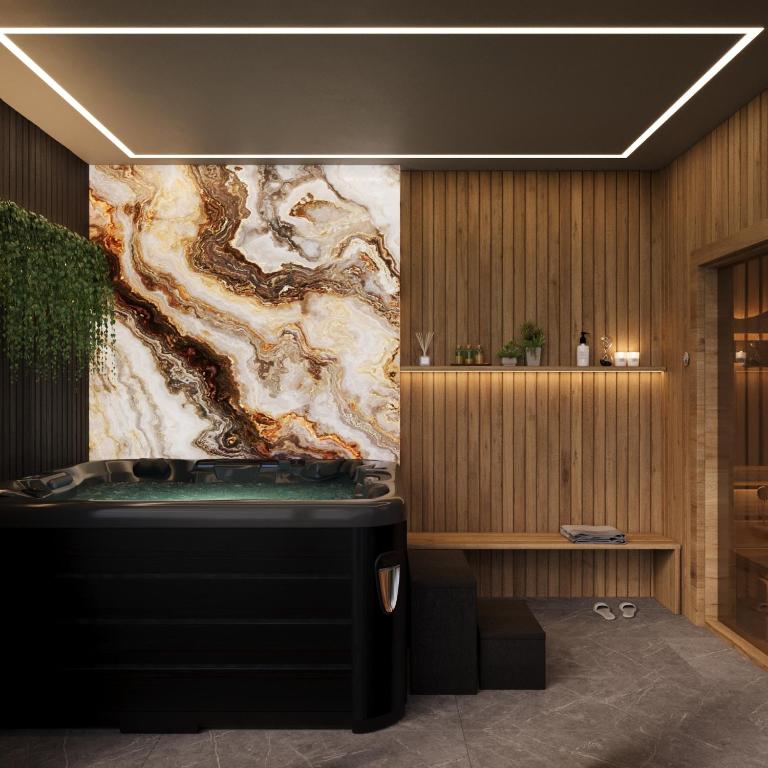a bathtub in a room with a marble wall at Novobilski przy Termie Bania i Kotelnicy - sauna, jacuzzi, restauracja, pokój zabaw, wypożyczalnia rowerów e-bike in Białka Tatrzańska