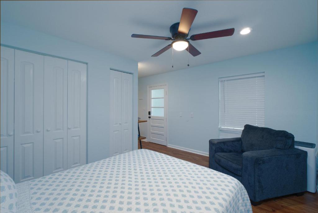 a bedroom with a bed and a ceiling fan and a chair at Dolphin Retreat in Brunswick