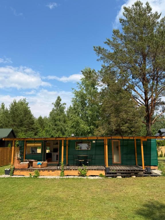 a green modular house with a yard at Przystanek Natura in Gorczyca
