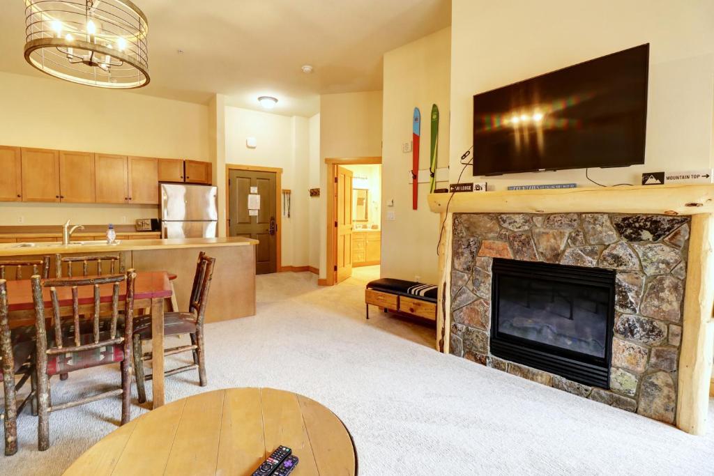a living room with a fireplace with a television above it at CS425 Copper Springs in Copper Mountain