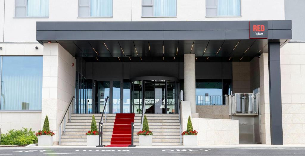 a building with a red staircase in front of it at Radisson RED Galway in Galway