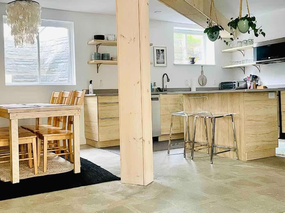 a kitchen with a table and some chairs and a counter at The Bunker - Ski Shuttle Shopping Center in Stowe