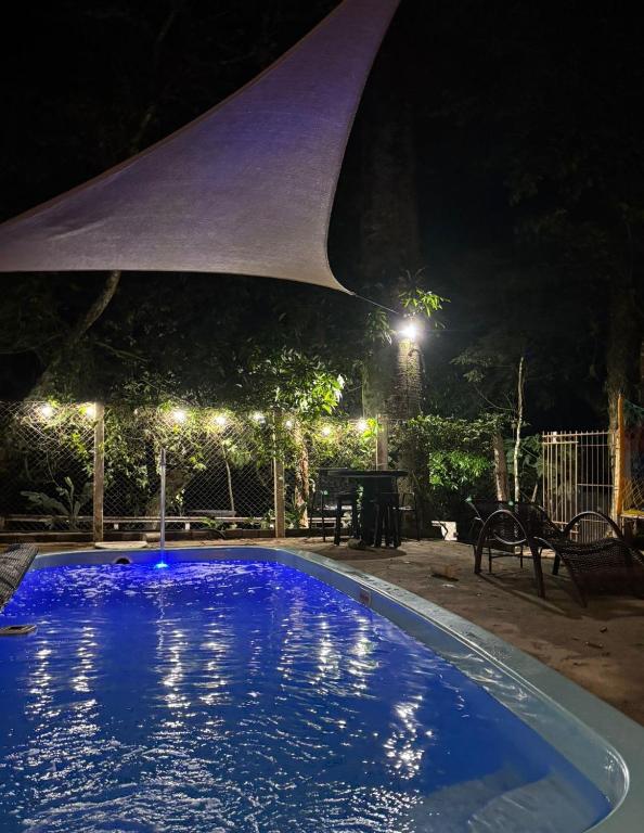 a large swimming pool at night with lights at Casa Beira Rio in Araras