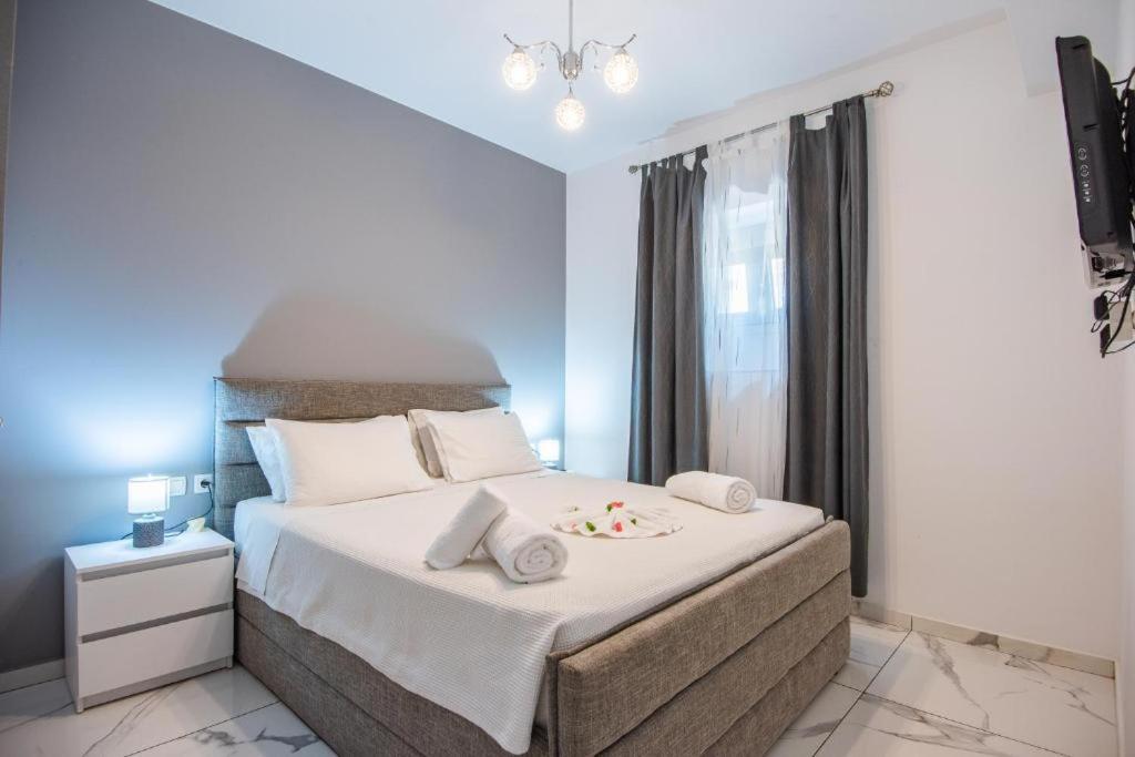 a bedroom with a large bed with white sheets and pillows at Ermira in Agios Nikolaos