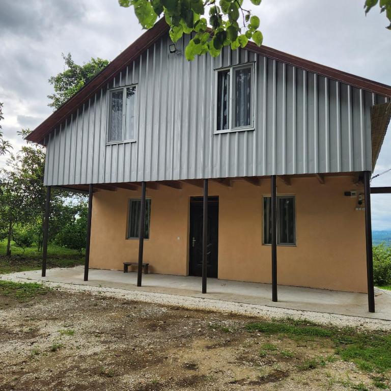 a building with two doors and a porch at Сабудара in Martvili