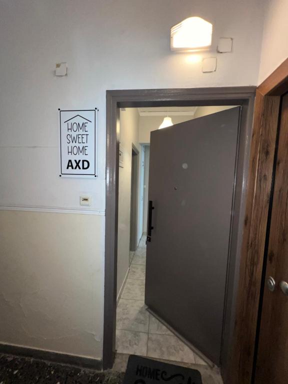a door in a hallway with a sign on the wall at Home Sweet Home AXD in Alexandroupoli