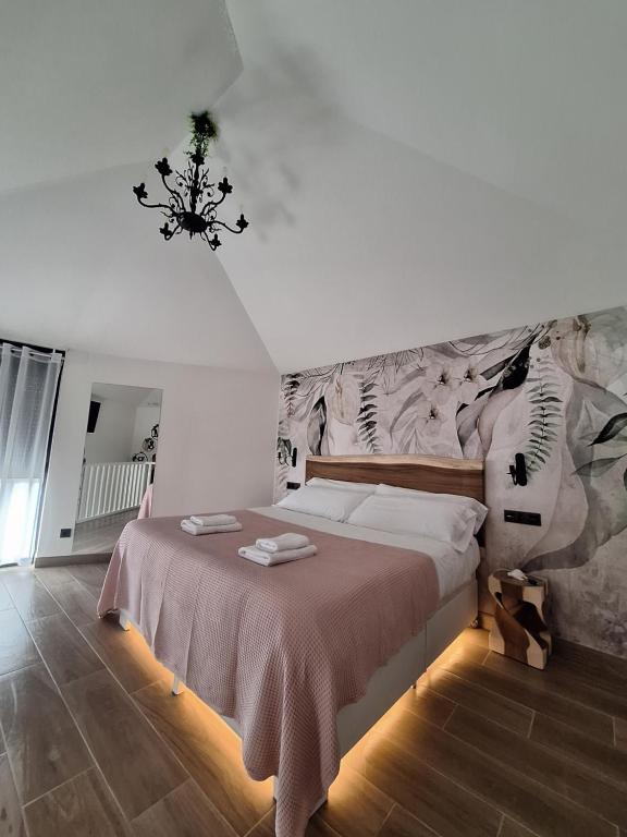 a bedroom with a large bed with a wall mural at Casa Rita M & R in Lires