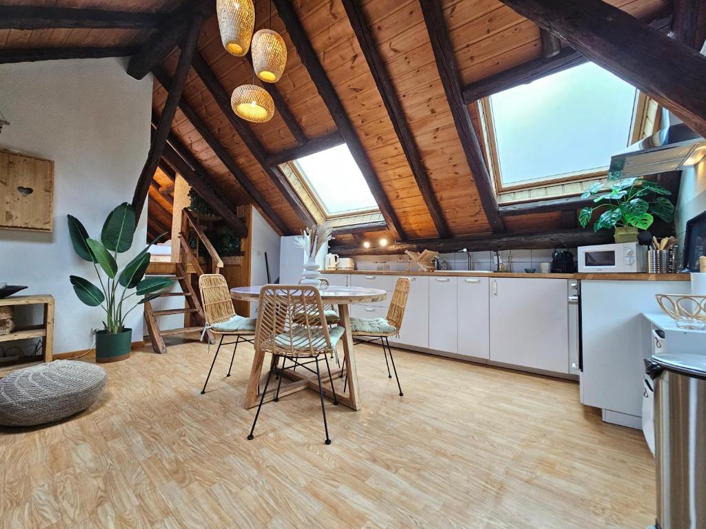 a kitchen with a table and chairs in a room at Acolin in Briançon