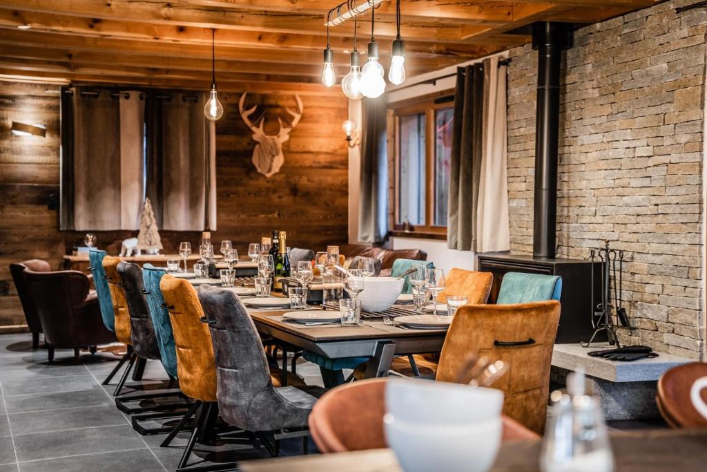 a dining room with a long table and chairs at Izoard in Saint-Chaffrey