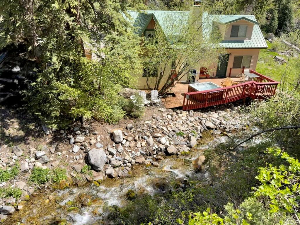 an aerial view of a house with a river at Cottage On The Stream Sundance, Utah in Sundance
